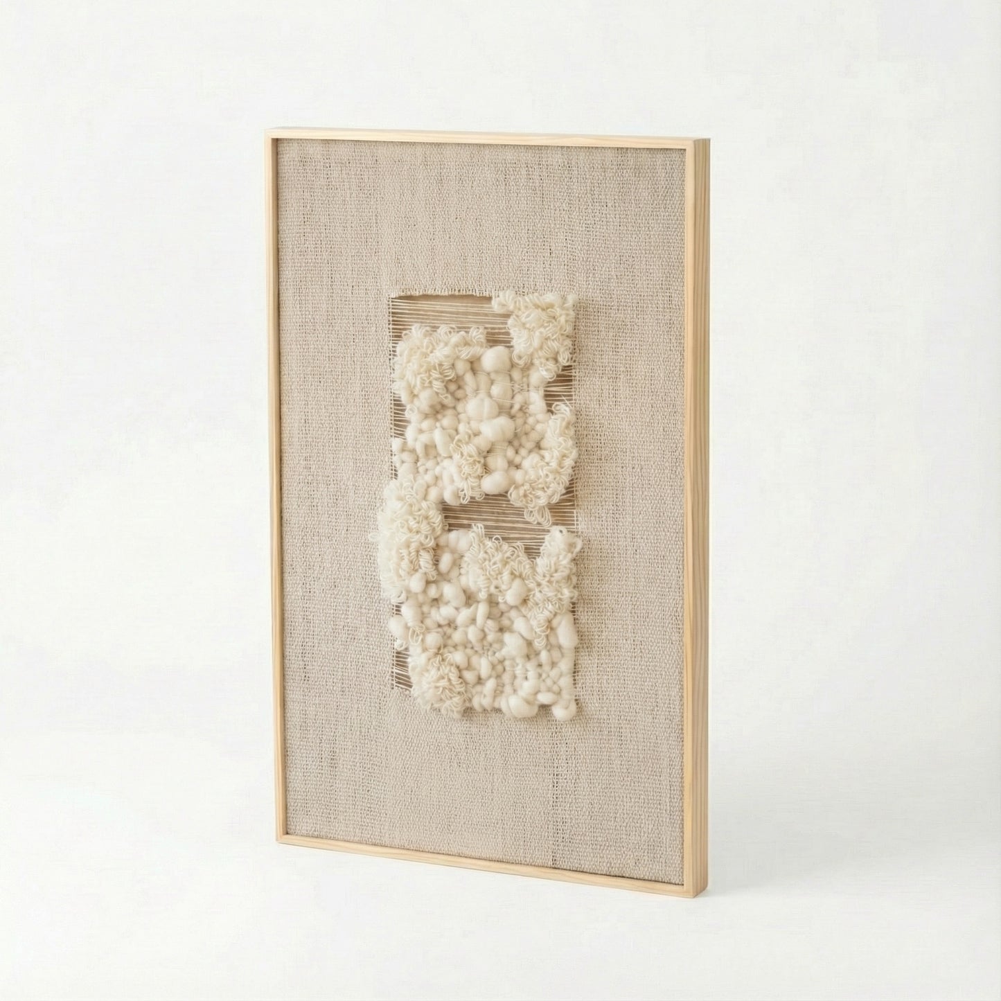 Framed textured wall art with white elements on a light background