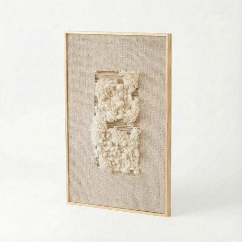 Framed textured wall art with white elements on a light background