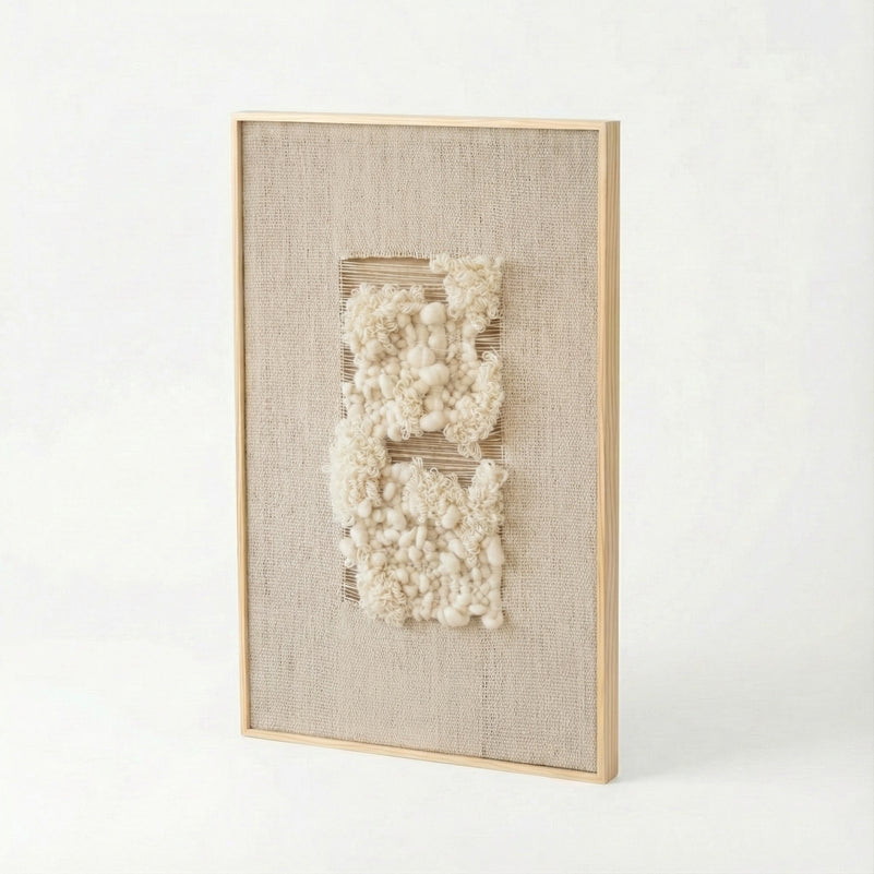 Framed textured wall art with white elements on a light background