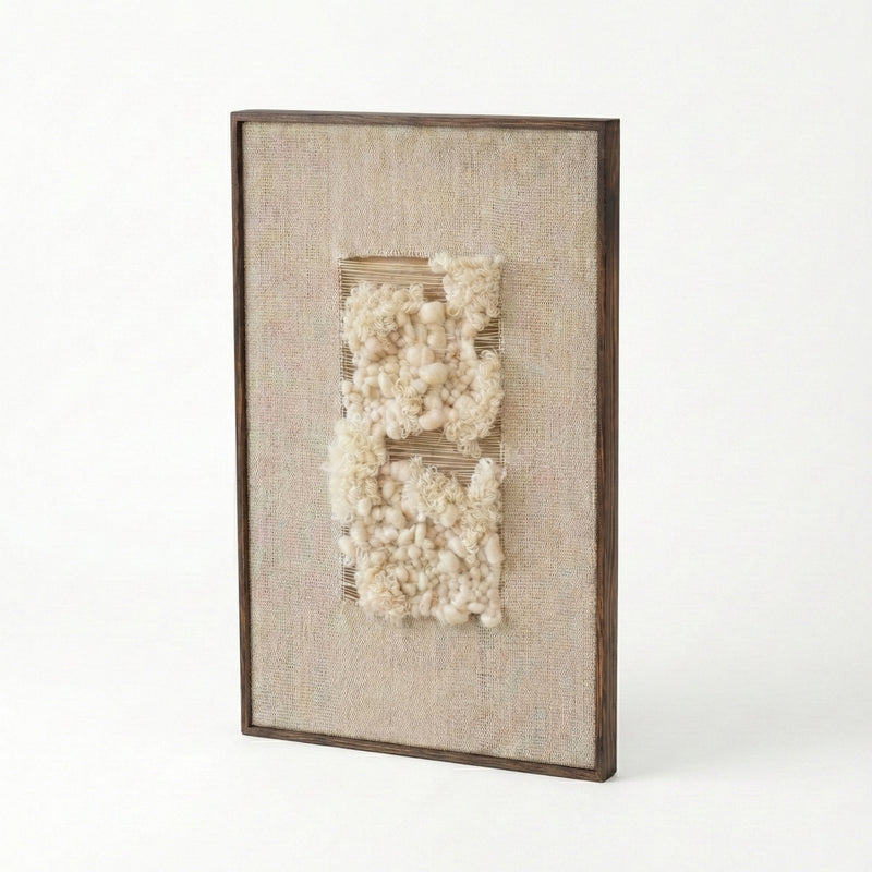 Decorative wall art with textured white elements in a brown frame on a white background